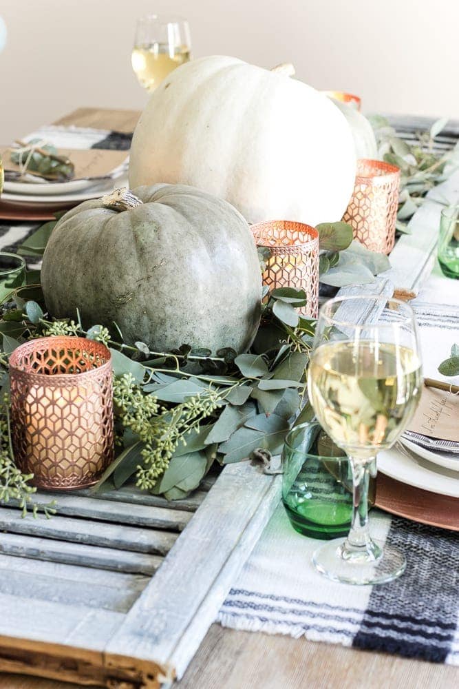 shutter table runner filled with pumpkins, eucalyptus, and copper candle holders 