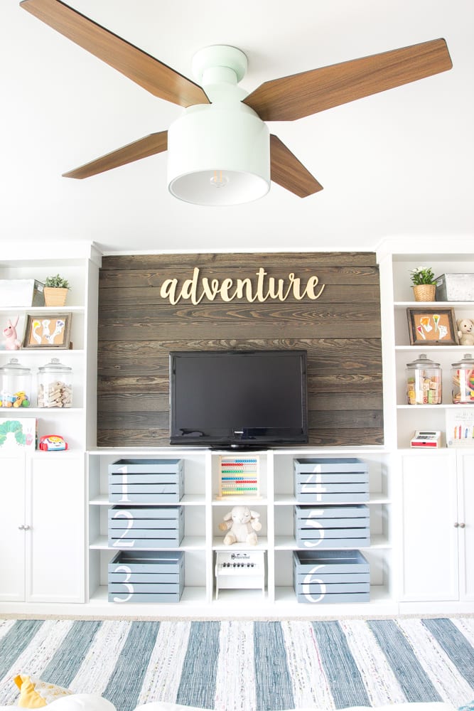 wood plank wall treatment with white built-ins in a playroom