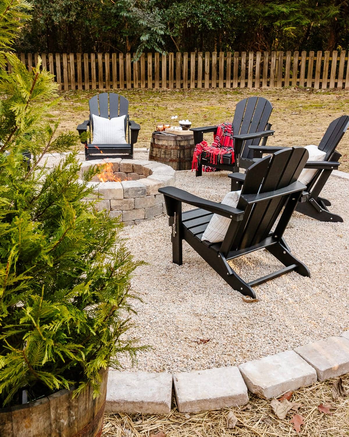 diy backyard fire pit with pea gravel, stone edgers, and adirondack chairs