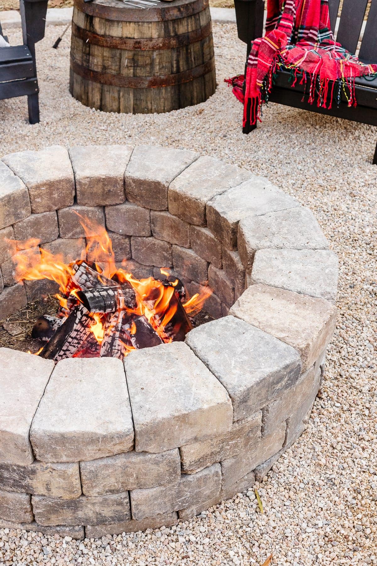 stone diy backyard fire pit with pea gravel and adirondack chairs