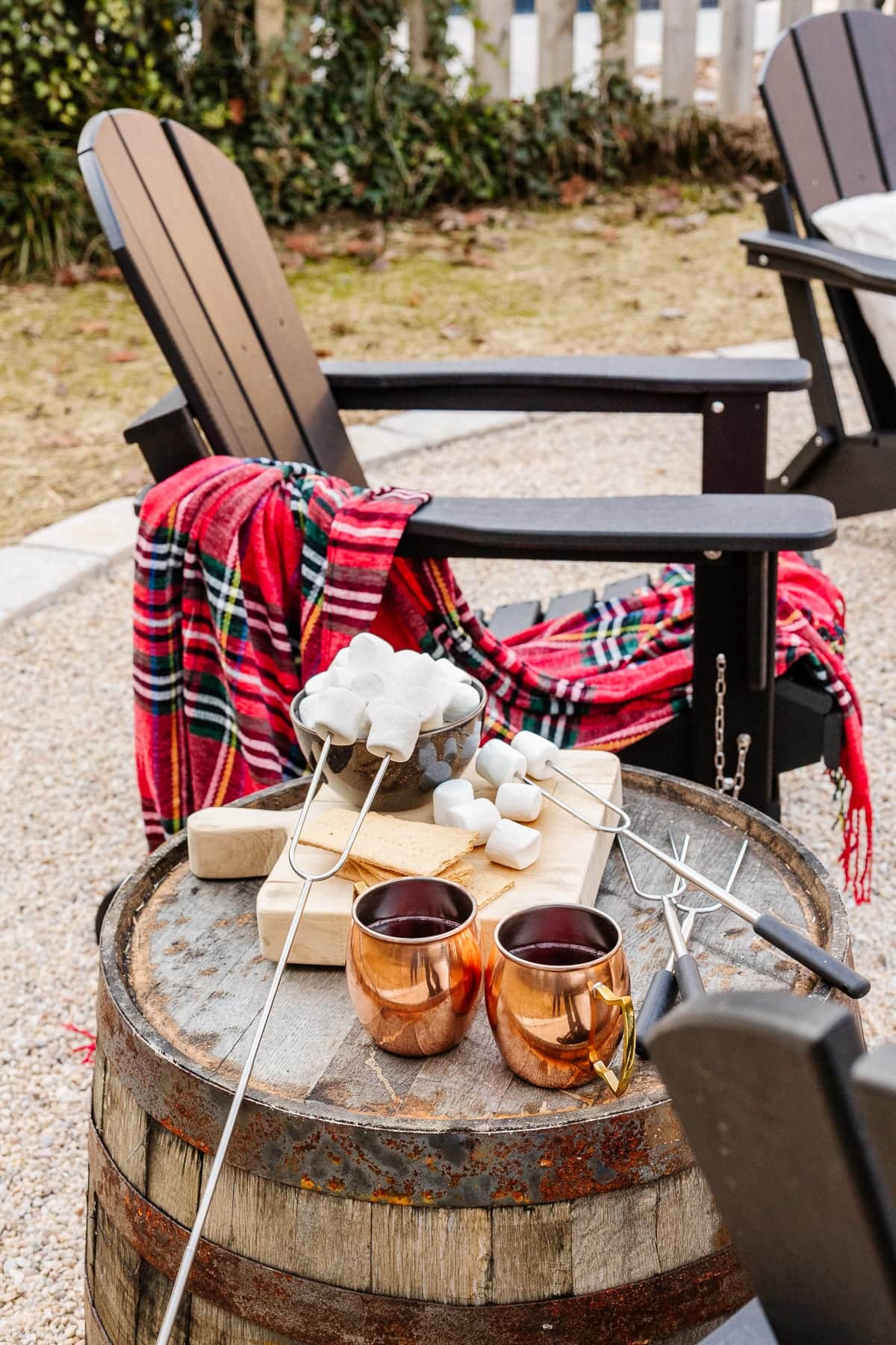 Adirondack chair with barrel side table and s'mores ingredients 