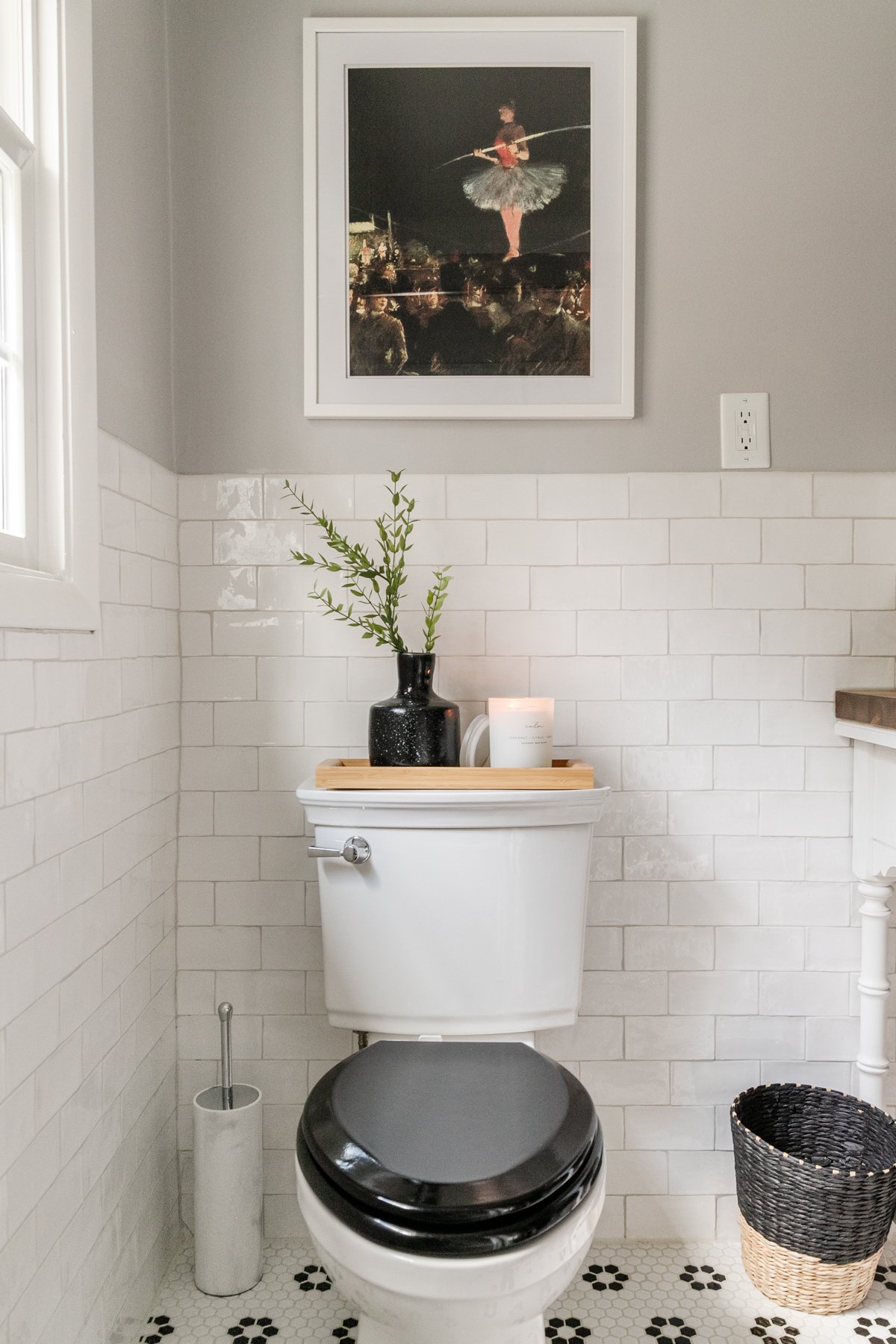 black and white bathroom with aesthetic toilet brush storage beside toilet