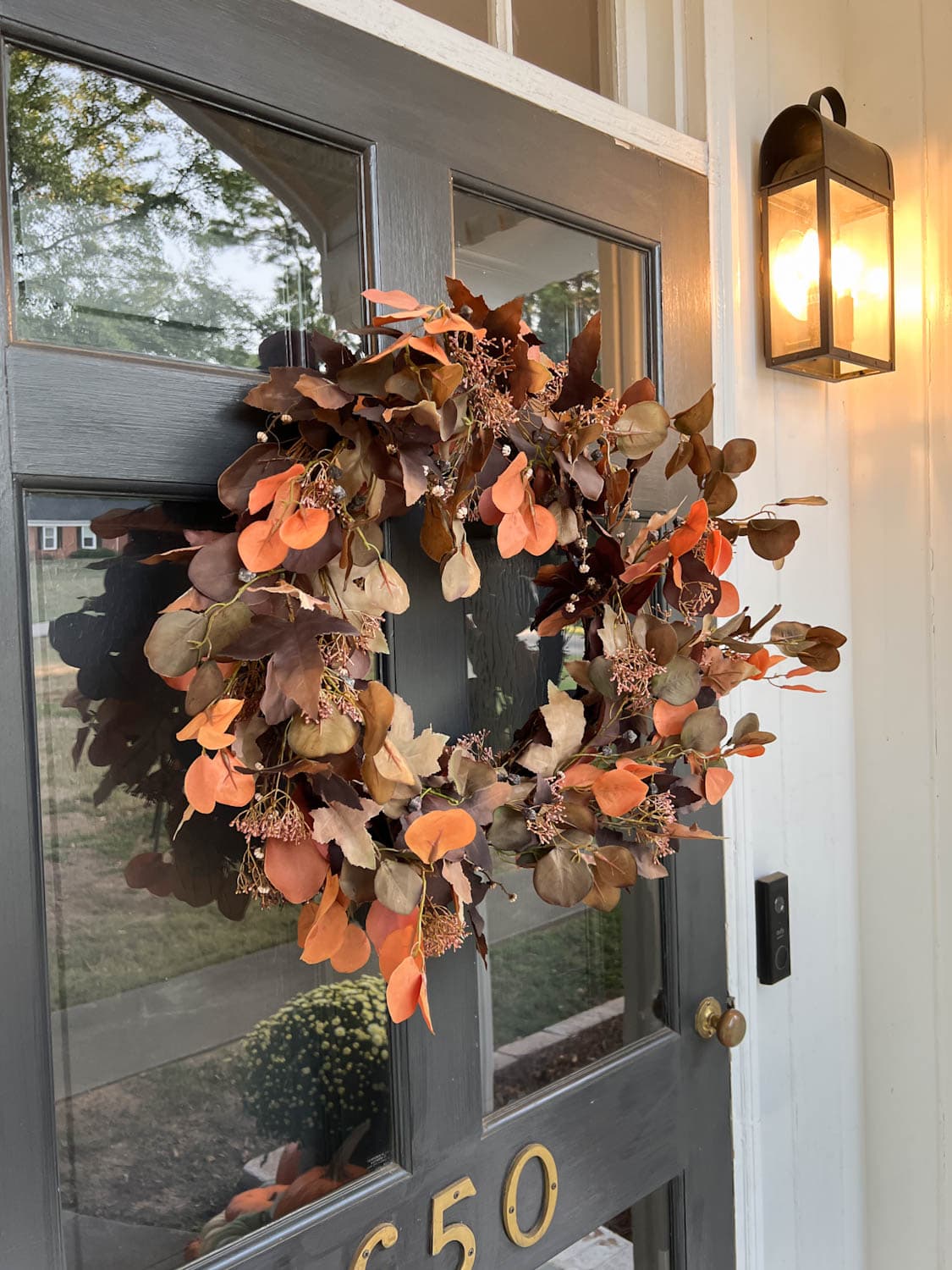 artificial fall wreath on a front door