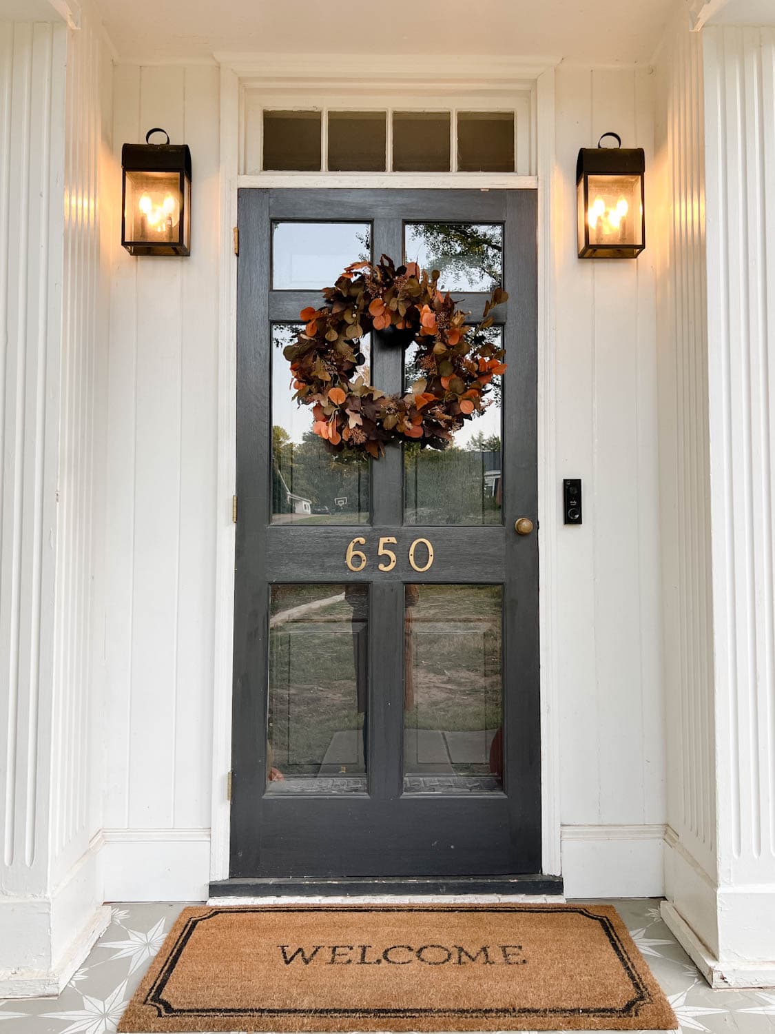 front porch door with realistic artificial fall wreath