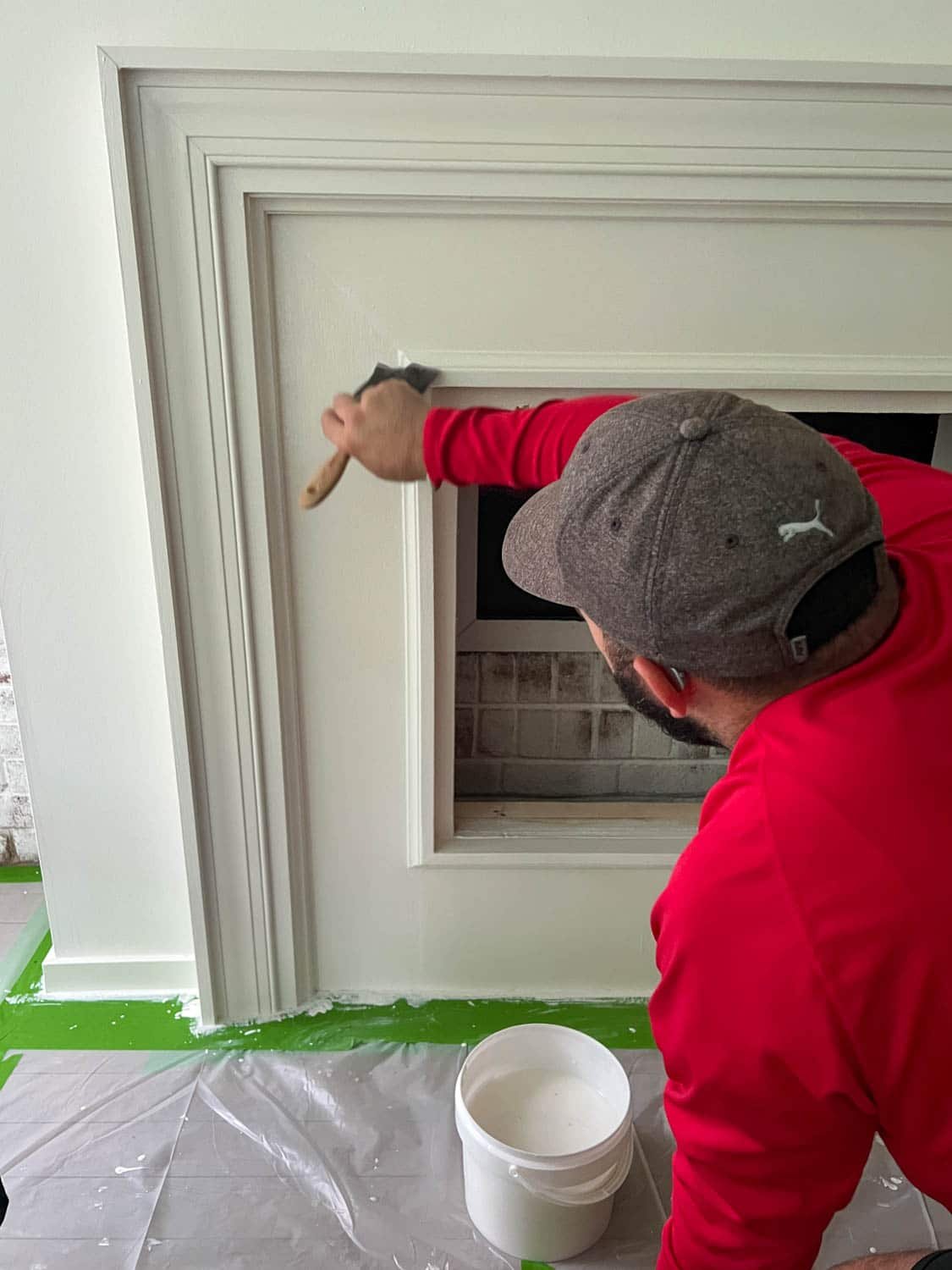brushing fireplace surround with plaster paint