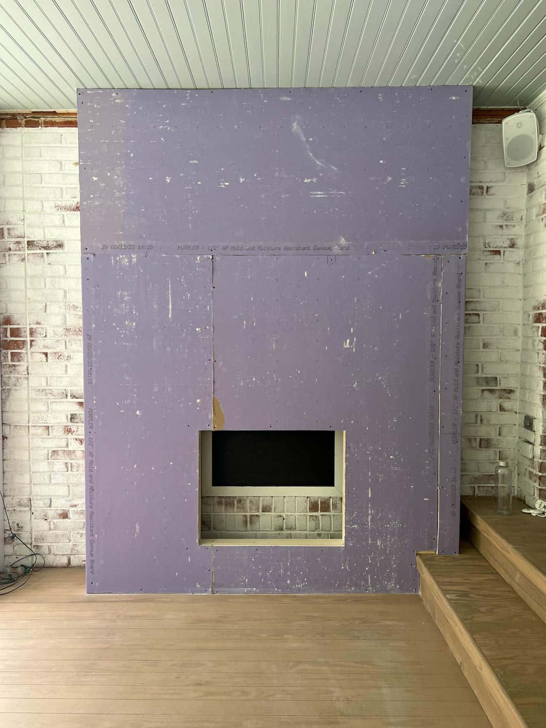 purple drywall hung on a fireplace frame