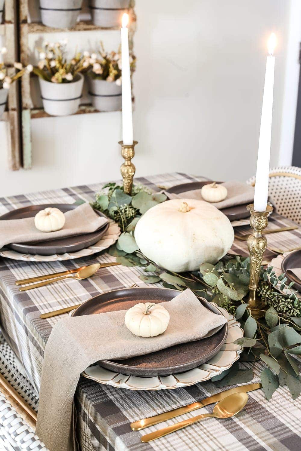 Neutral Low-Key Thanksgiving Tablescape | blesserhouse.com - A neutral low-key Thanksgiving tablescape that is simple and inexpensive to recreate using plaid fabric, white pumpkins, eucalyptus, and brass.